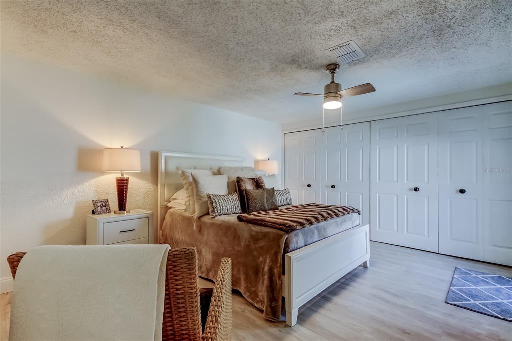 12625 Shell Point Drive Hudson, FL 34667 - Photo 36 of 61 a bed room with a bed and a chandelier