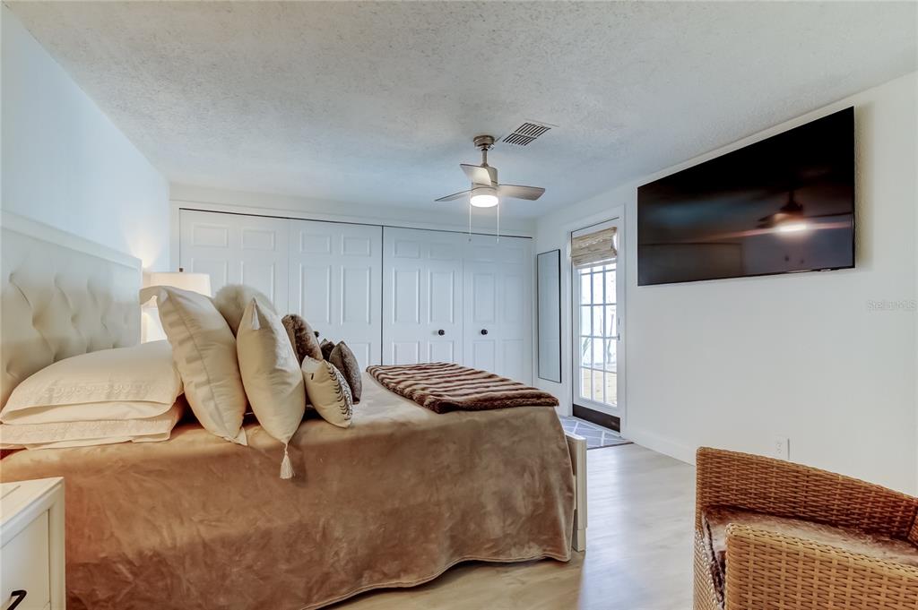 12625 Shell Point Drive Hudson, FL 34667 - Photo 37 of 61 a bedroom with a bed and a flat screen tv