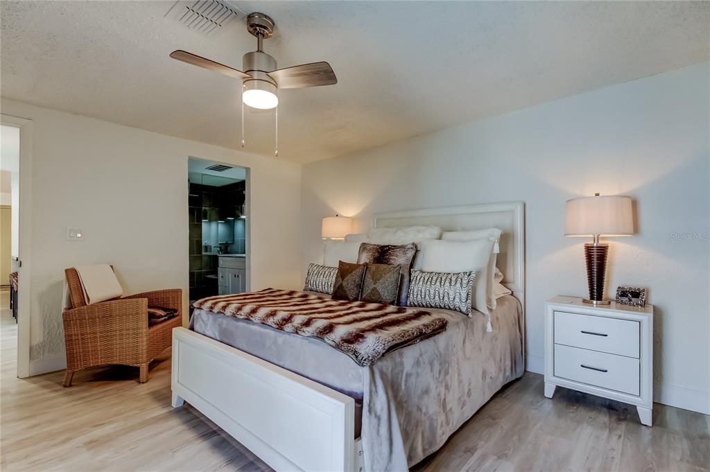 12625 Shell Point Drive Hudson, FL 34667 - Photo 38 of 61 a bedroom with a bed and wooden floor