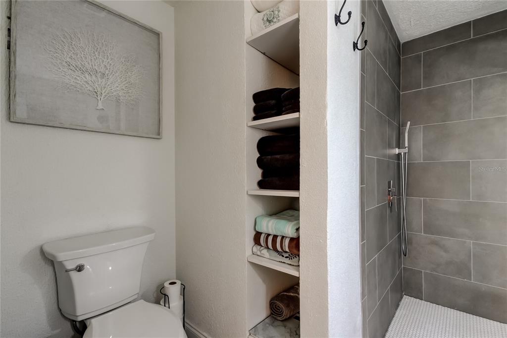 12625 Shell Point Drive Hudson, FL 34667 - Photo 42 of 61 a white toilet sitting next to a bathroom sink