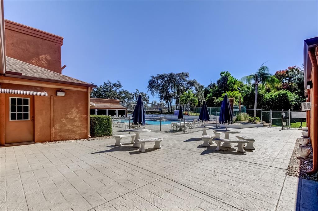 12625 Shell Point Drive Hudson, FL 34667 - Photo 57 of 61 a view of a patio with dining table and chairs with wooden fence