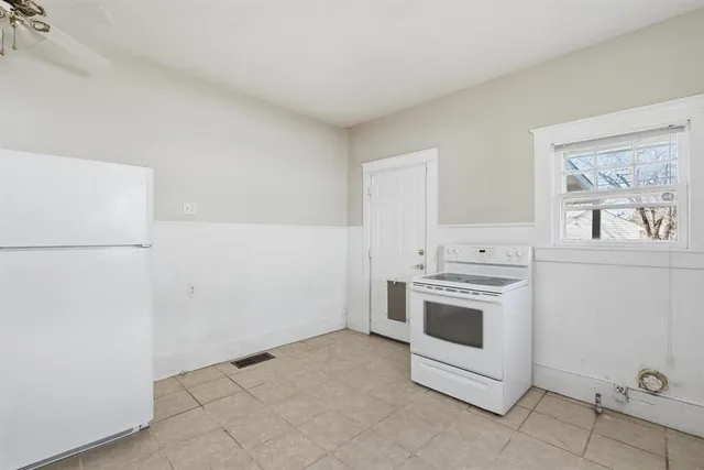 a kitchen with a stove and a refrigerator