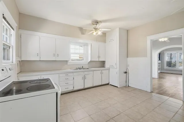 a kitchen with a sink cabinets and chandelier