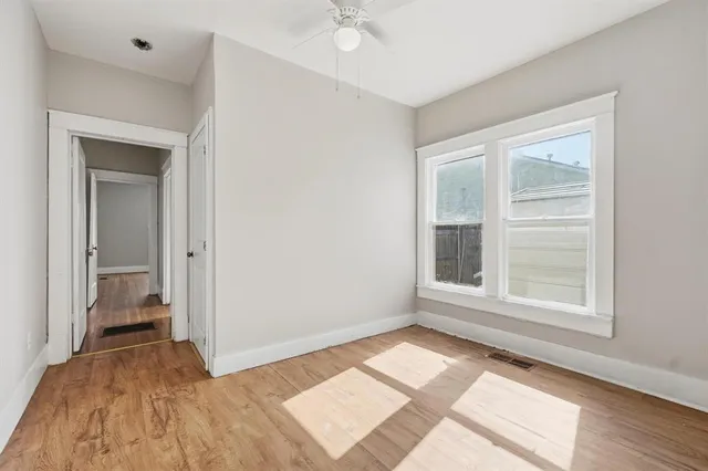 a view of a room with wooden floor and a bathroom