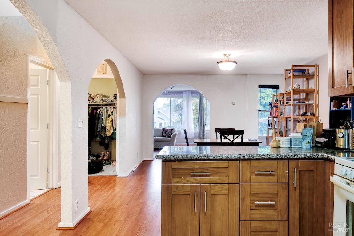 1128 Chester Street Oakland, CA 94607 - Photo 11 of 42 a view of a granite countertop cabinets and a wooden floor