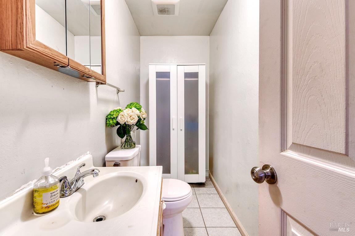 1128 Chester Street Oakland, CA 94607 - Photo 14 of 42 a bathroom with a sink mirror and vanity
