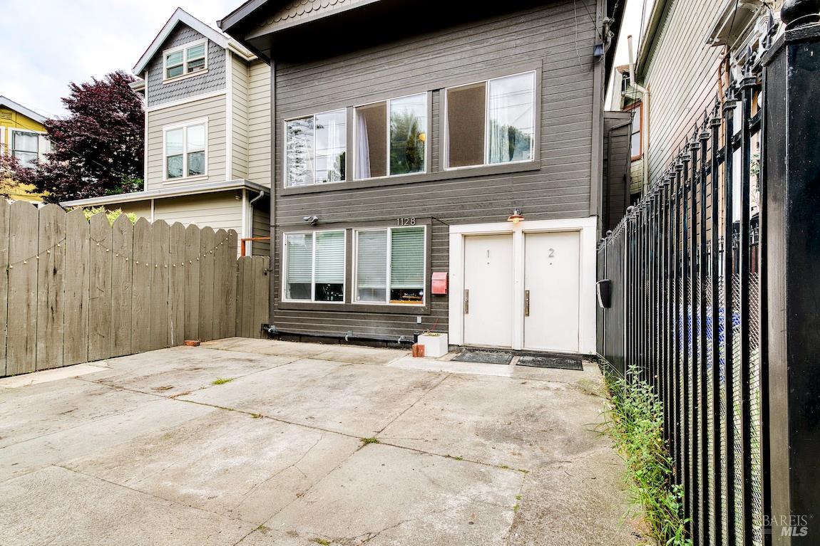 1128 Chester Street Oakland, CA 94607 - Photo 42 of 42 a view of a house with a small yard and wooden fence