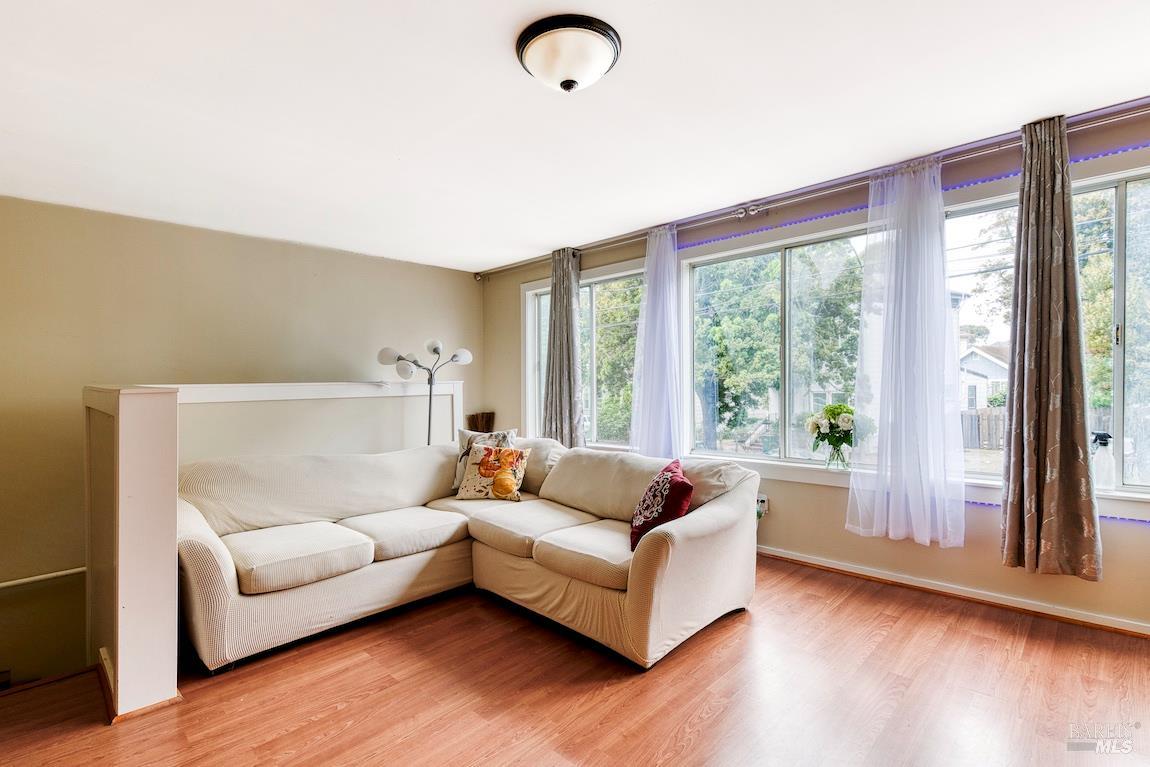 1128 Chester Street Oakland, CA 94607 - Photo 7 of 42 a living room with furniture and a large window