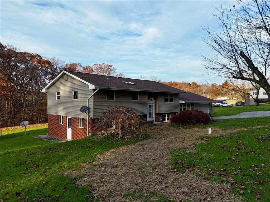 a view of house with backyard