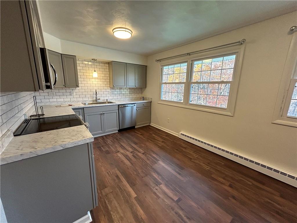 1631 Shady Plain Road Apollo, PA 15613 - Photo 11 of 36 a large kitchen with granite countertop a sink dishwasher stove and cabinets