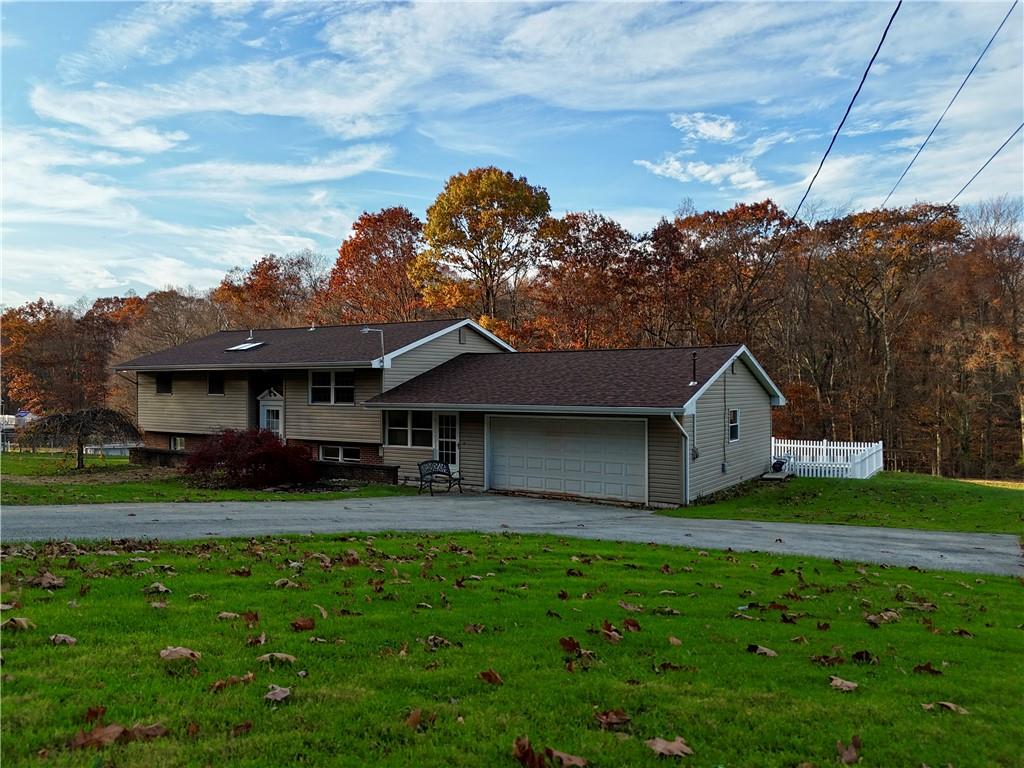1631 Shady Plain Road Apollo, PA 15613 - Photo 2 of 36 a front view of a house with a garden and deck