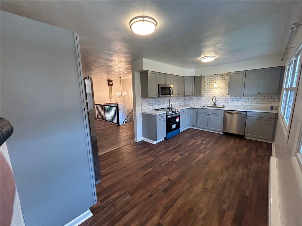 1631 Shady Plain Road Apollo, PA 15613 - Photo 8 of 36 a large kitchen with a wooden floor and stainless steel appliances