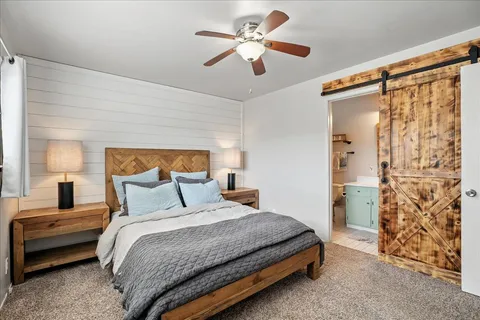 a bedroom with a bed and a chandelier