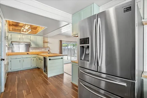 a kitchen with a refrigerator and a sink
