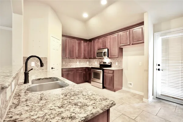 a spacious bathroom with a granite countertop tub sink and mirror