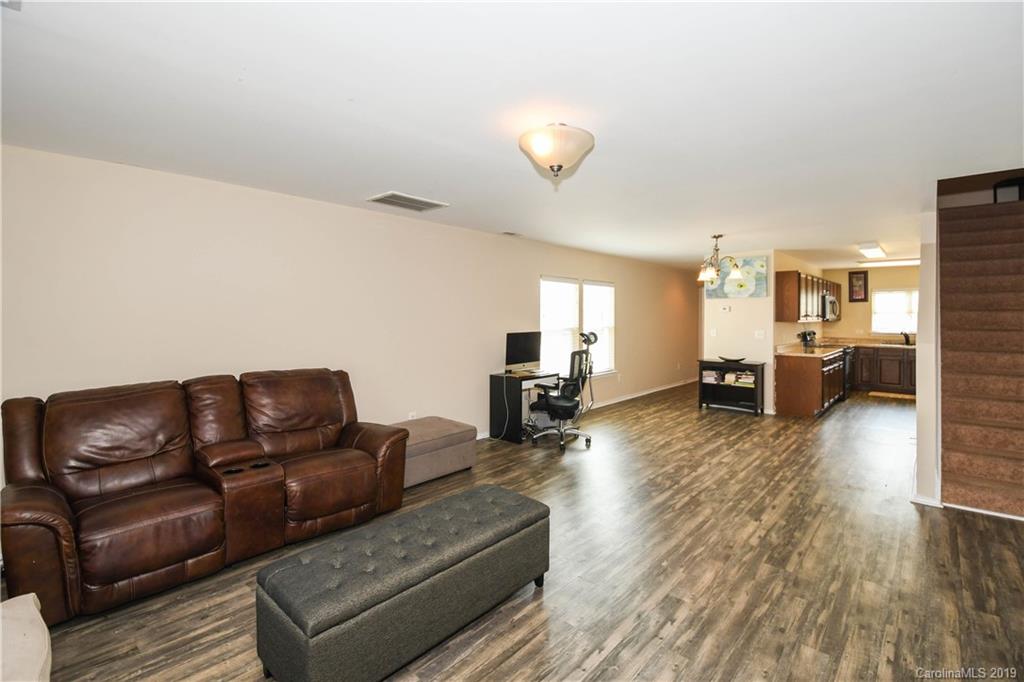 660 Potter Place Road Fort Mill, SC 29708 - Photo 6 of 23 a living room with furniture and a wooden floor