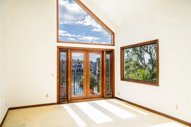 a view of a front door and bedroom from a window