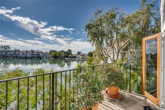 a view of swimming pool with a yard and palm trees