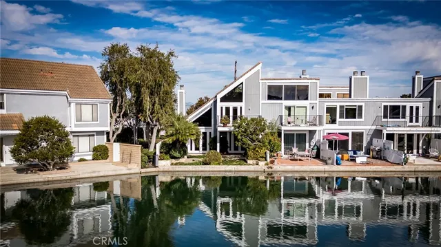 an aerial view of a house with swimming pool and ocean view