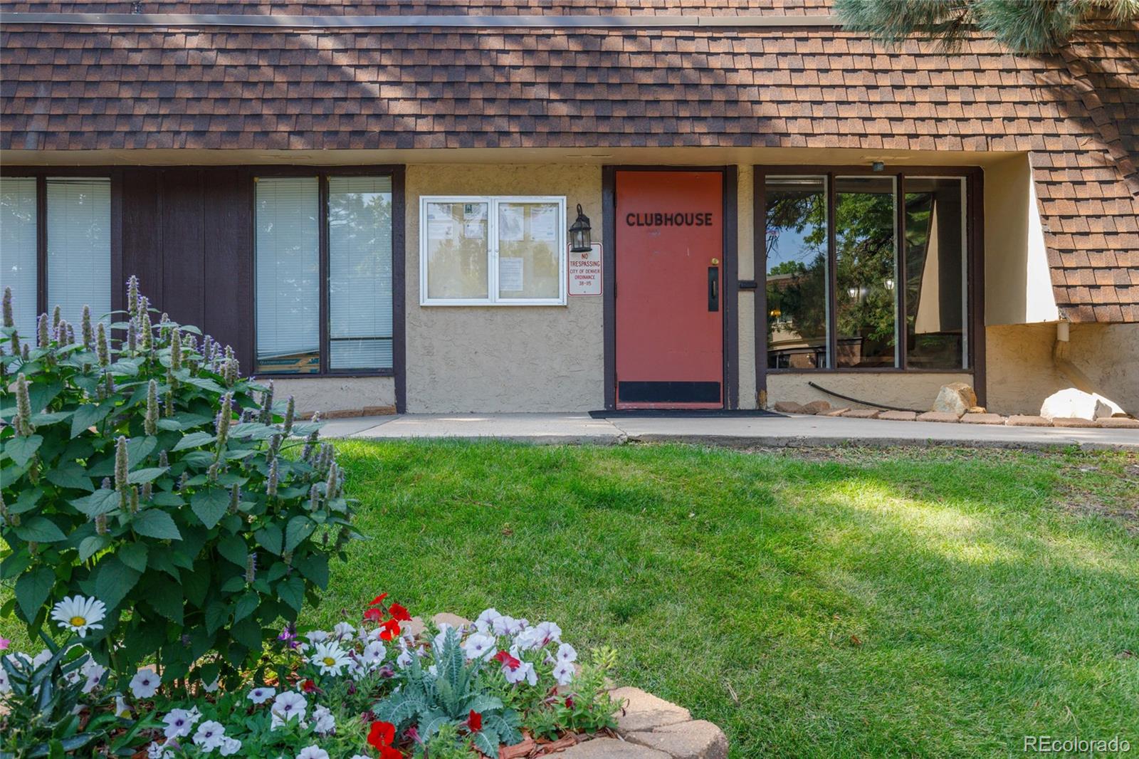 7755 East Quincy Avenue, Unit 205A5 Denver, CO 80237 - Photo 21 of 23 a front view of a house with a yard