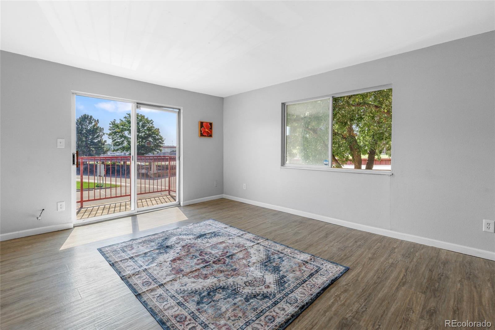 7755 East Quincy Avenue, Unit 205A5 Denver, CO 80237 - Photo 4 of 23 a view of an empty room with wooden floor and a window