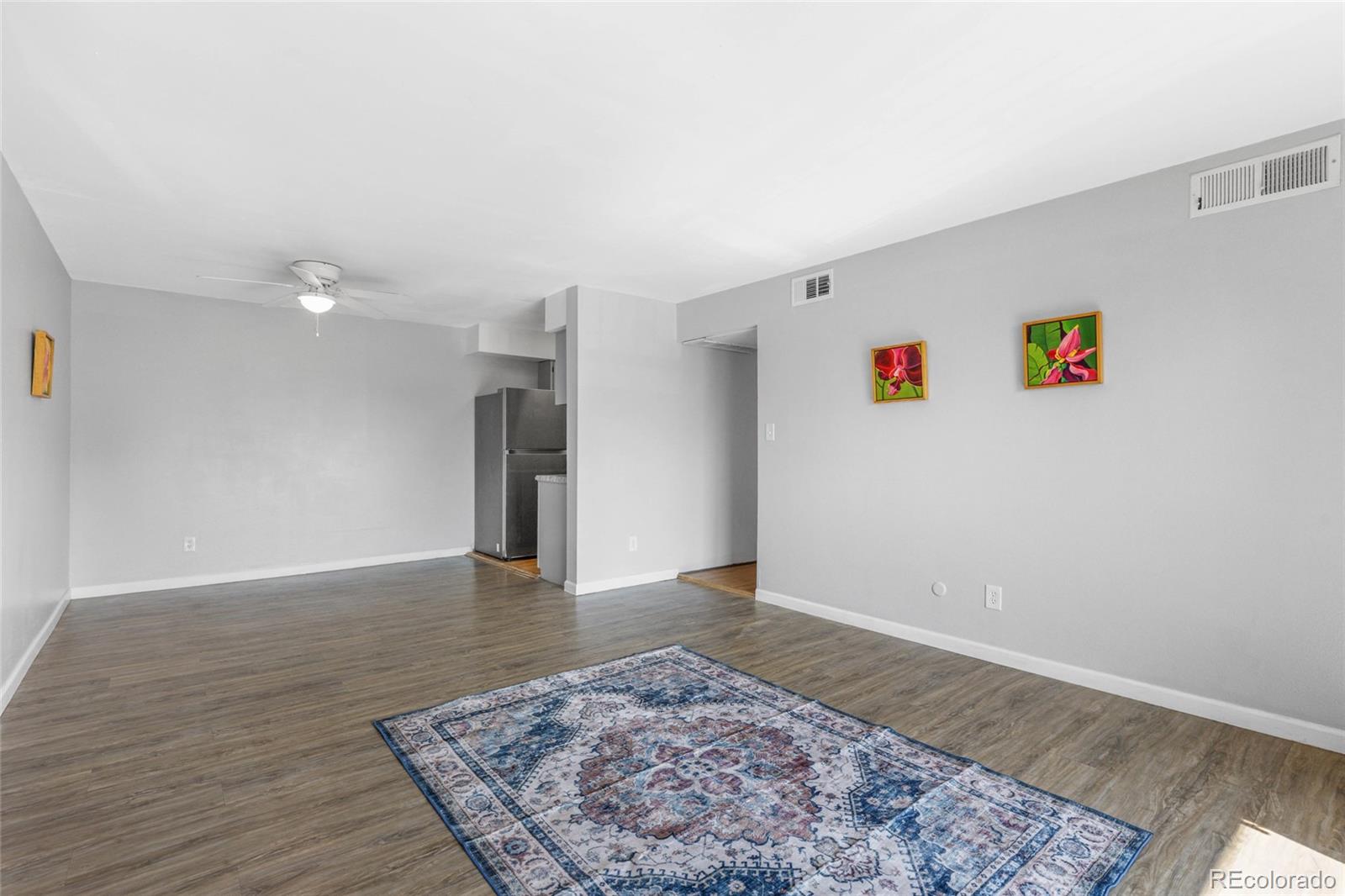 7755 East Quincy Avenue, Unit 205A5 Denver, CO 80237 - Photo 5 of 23 a view of a big room with wooden floor and windows