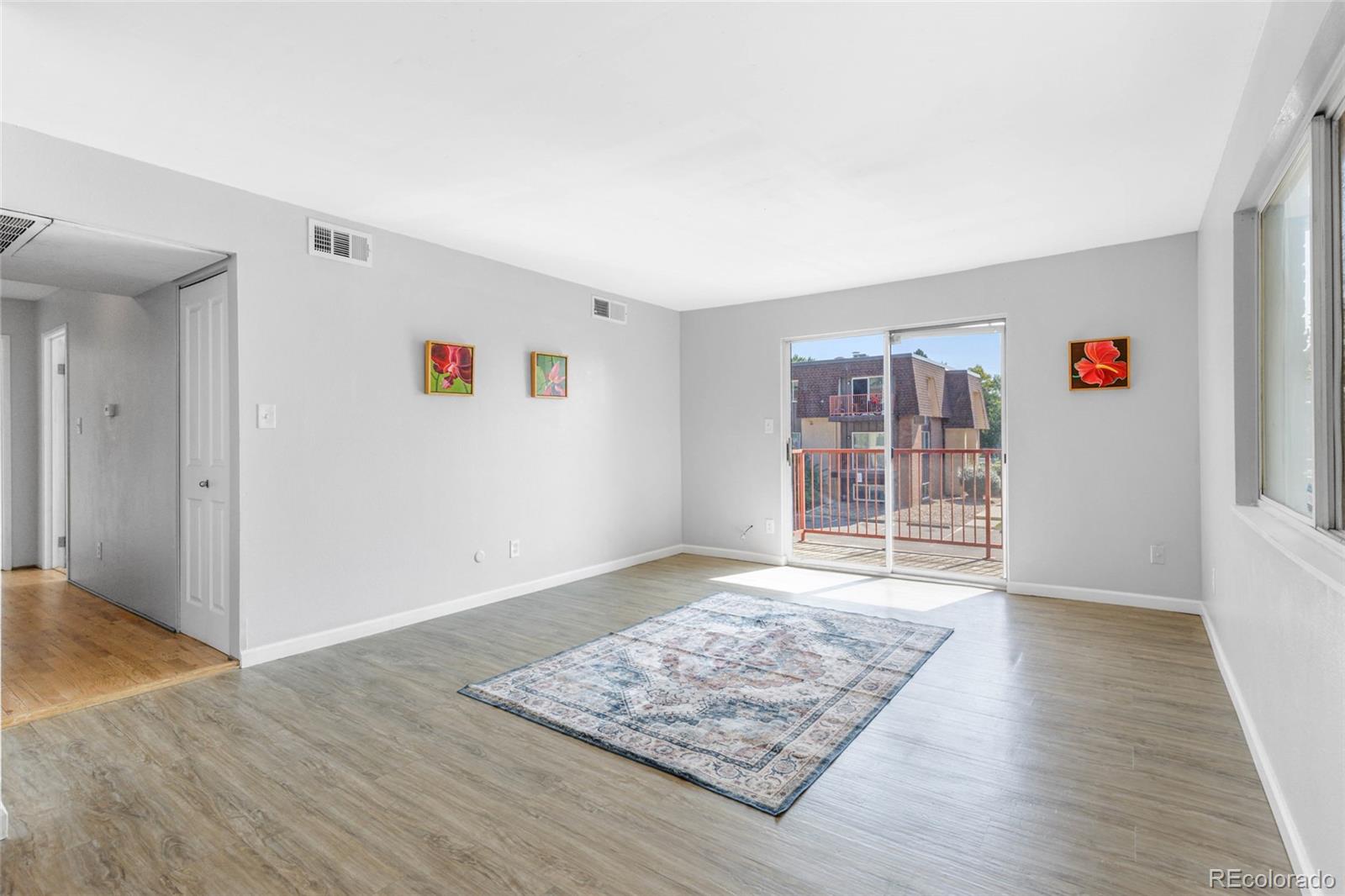 7755 East Quincy Avenue, Unit 205A5 Denver, CO 80237 - Photo 6 of 23 an empty room with wooden floor and window