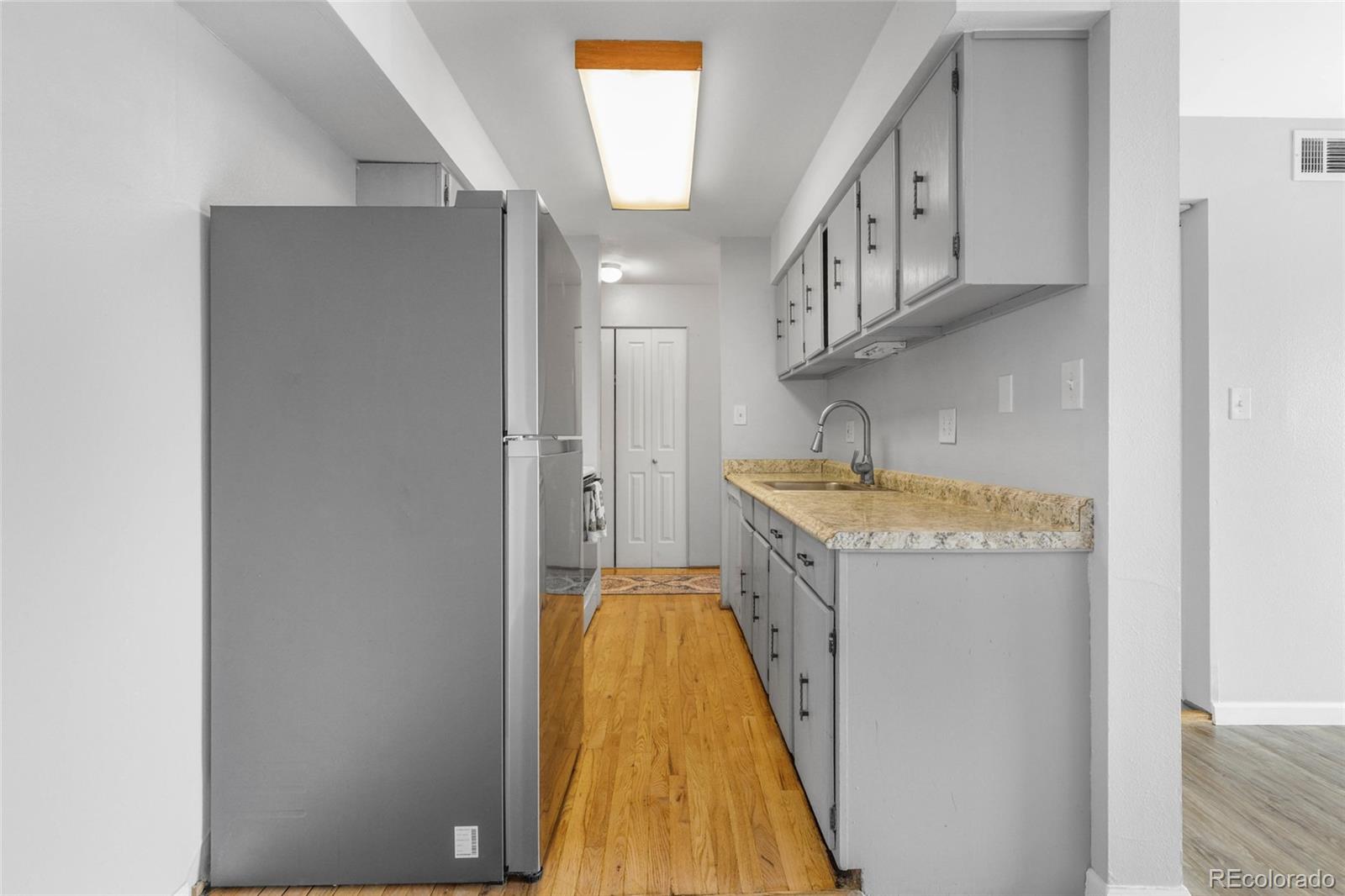 7755 East Quincy Avenue, Unit 205A5 Denver, CO 80237 - Photo 10 of 23 a bathroom with a granite countertop sink and a mirror