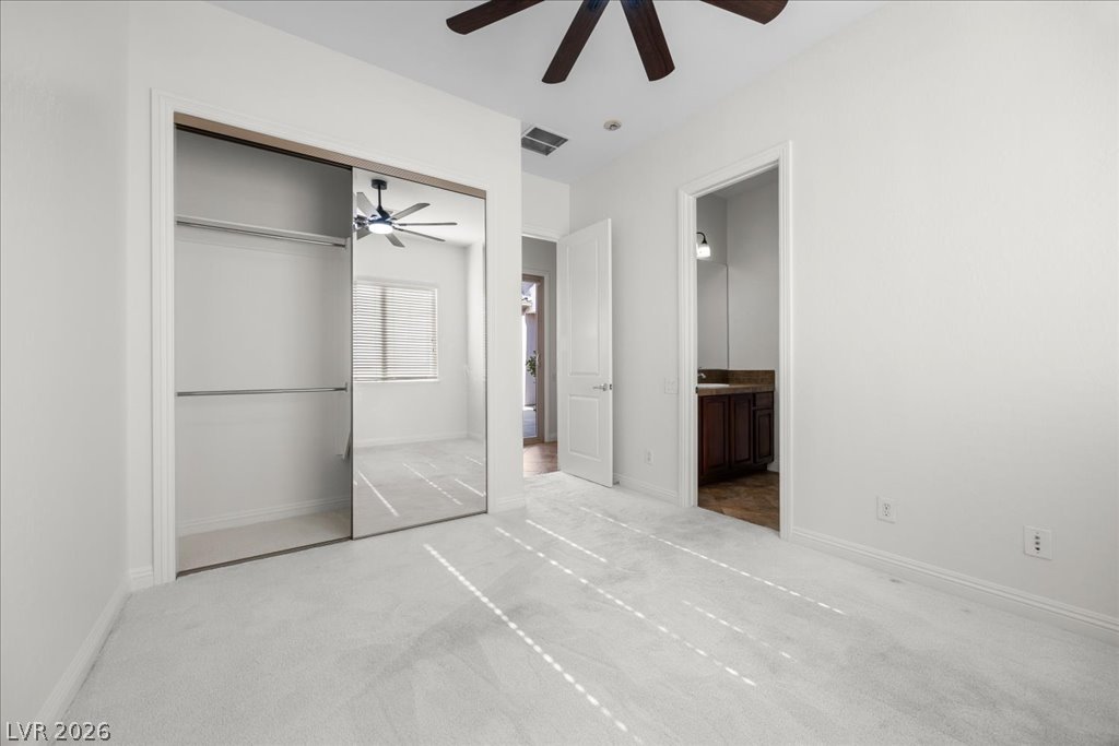 2125 De Rouge Avenue Henderson, NV 89044 - Photo 59 of 96 Well-lit room features soft carpeting and a ceiling fan for comfort.
