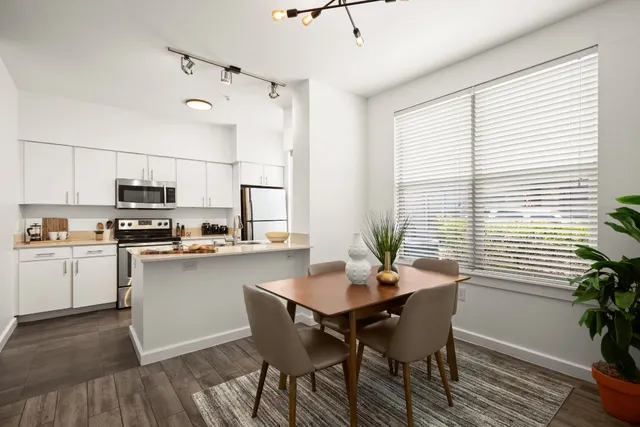 a kitchen with a table and chairs in it