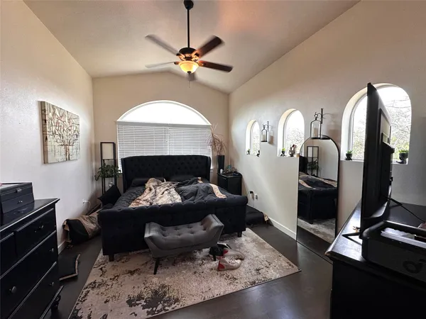 a living room with furniture and a mirror