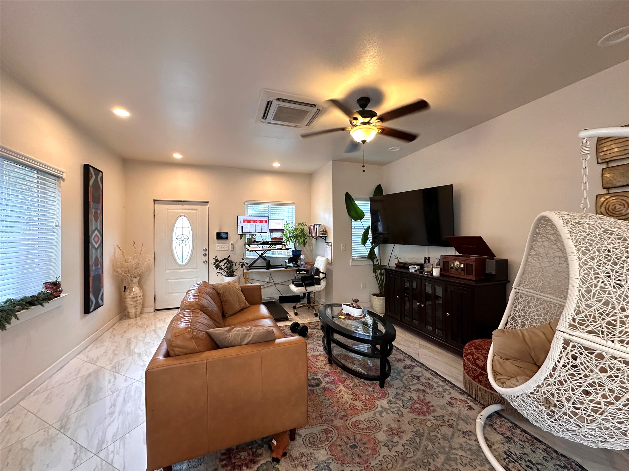 5004 Rowena Avenue, Unit A Austin, TX 78751 - Photo 6 of 24 a living room with furniture a flat screen tv and a window