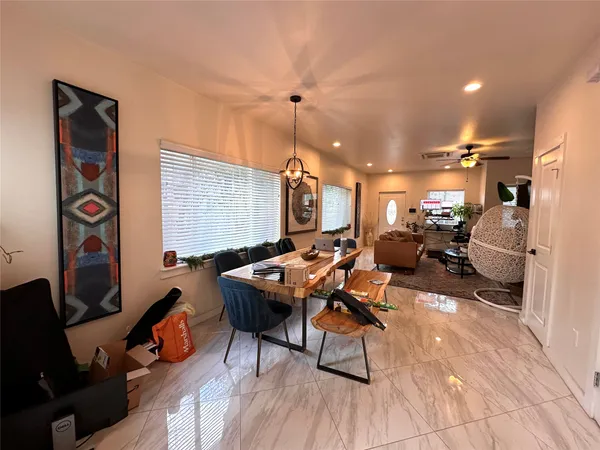 a living room with furniture a rug and a flat screen tv