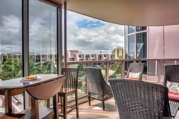 a view of a chairs and table in the balcony