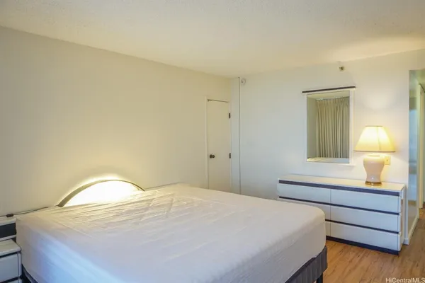 a bedroom with a bed and a lamp