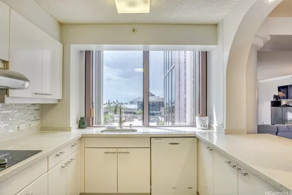 a view of a kitchen with a sink and cabinets