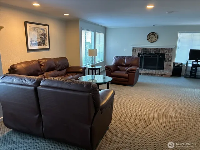 a living room with furniture and a kitchen