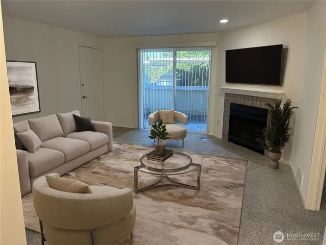 a living room with furniture a fireplace and a flat screen tv
