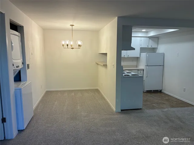 a view of a kitchen with refrigerator and mirror