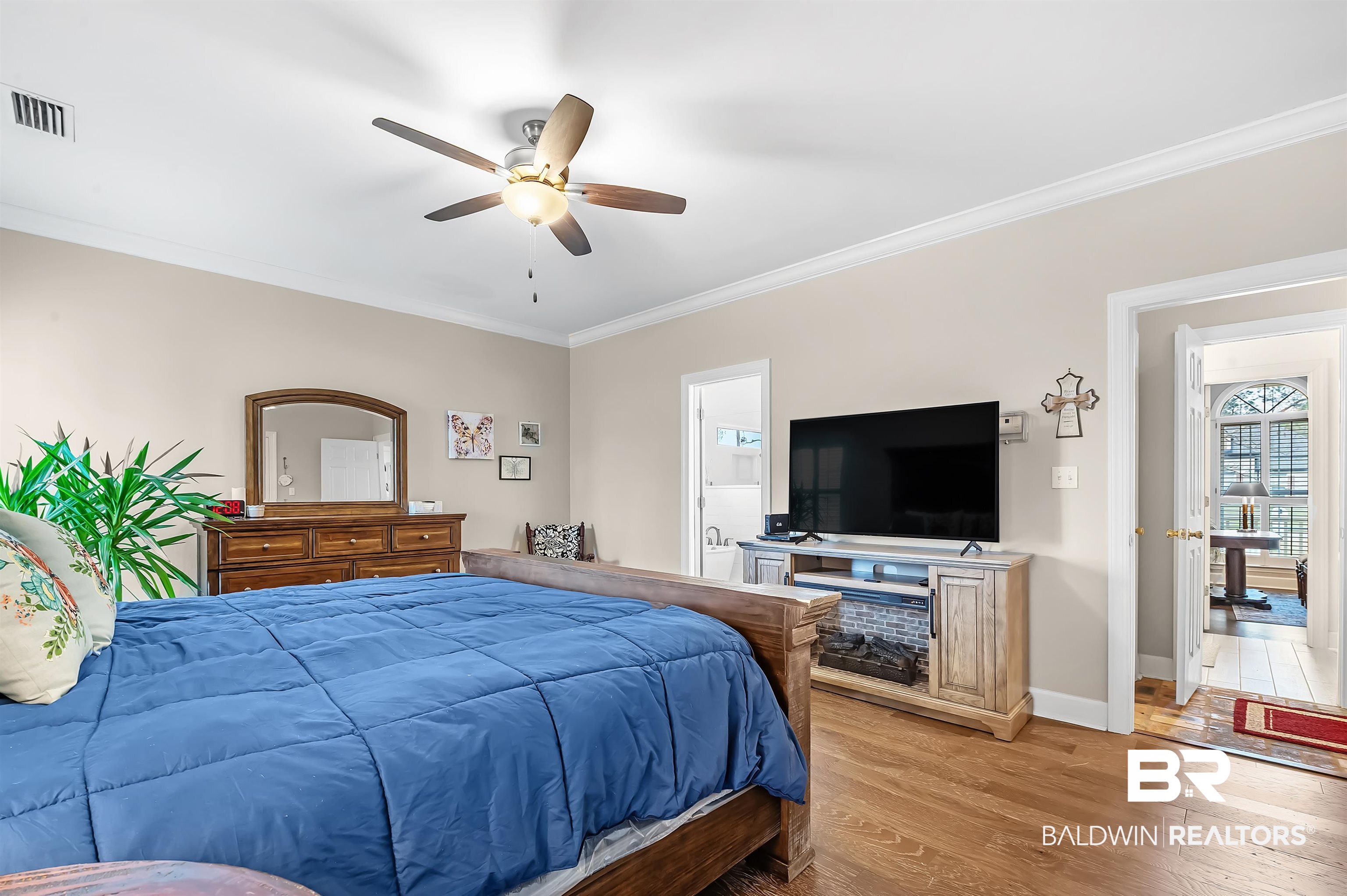 8915 Bay Point Drive Elberta, AL 36530 - Photo 50 of 74 Bedroom with ornamental molding, light wood finished floors, visible vents, and baseboards
