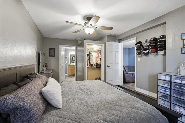a bedroom with a large bed and a chandelier