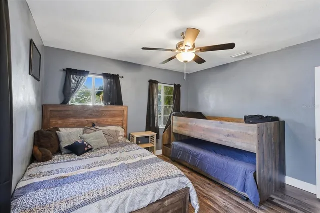 a bedroom with a bed and a chandelier