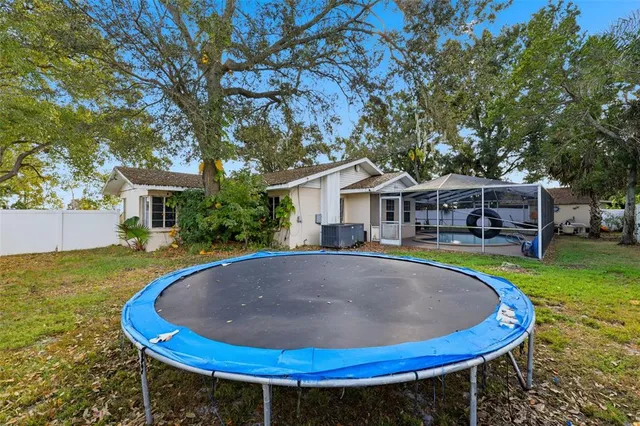 a view of a backyard with floor to ceiling window next to a yard
