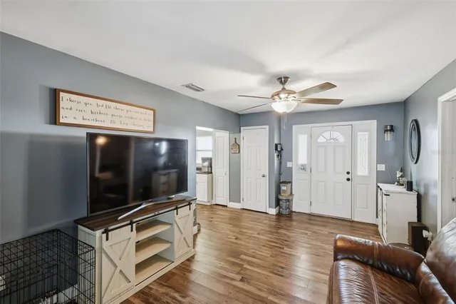a living room with furniture and a flat screen tv