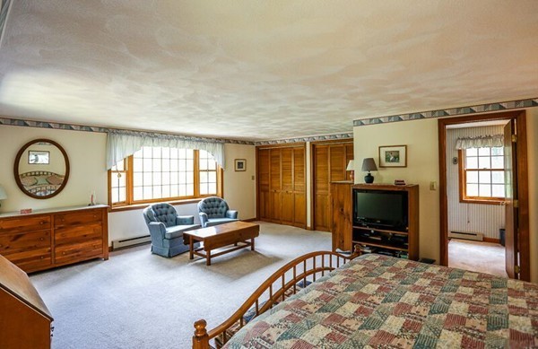 67 Bare Hill Road Topsfield, MA 01983 - Photo 14 of 22 a living room with furniture gym equipment and a flat screen tv