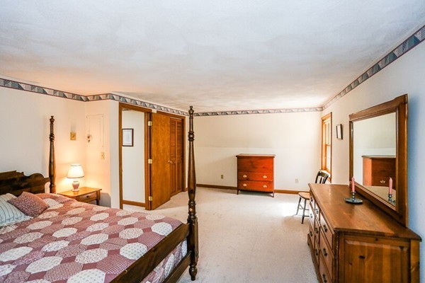 67 Bare Hill Road Topsfield, MA 01983 - Photo 17 of 22 a bedroom with a bed and wooden floor