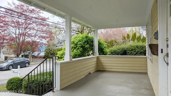 a bedroom with furniture and a wooden floor