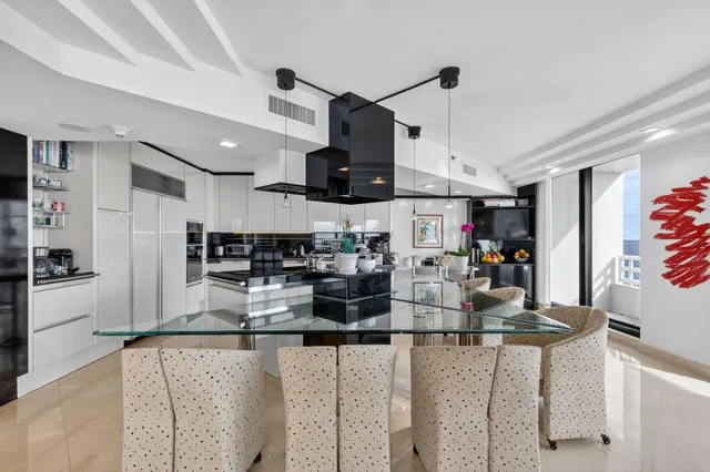 a kitchen with stainless steel appliances kitchen island granite countertop a sink and cabinets