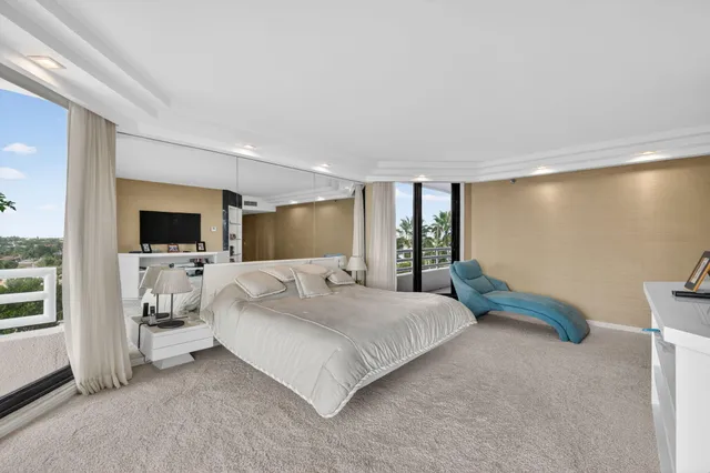 a view of a bedroom with furniture and window