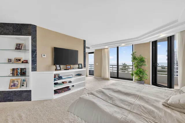 a bedroom with a large bed and a large window